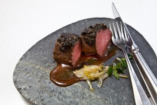 Silver-side New Zealand venison covered with black olive crust, garlic