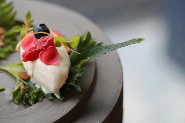 Ice cream on a bed of Shiso Leaves Green with Apple Blossom and Atsina Cress