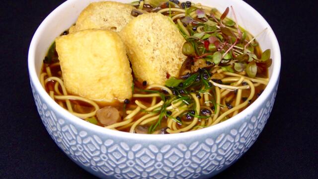 Egg noodle soup with bean curd and mushrooms